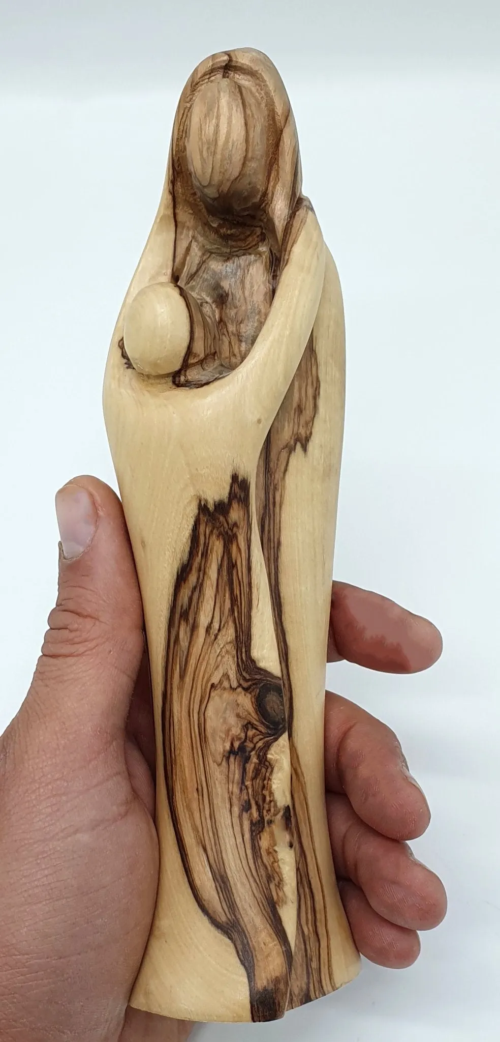 Experience the sublime beauty and intricate detailing of our Mary and Baby Jesus Handcrafted Olivewood Statue by Zuluf